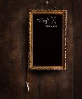 Old chalkboard on wood with copyspace for writing menu 