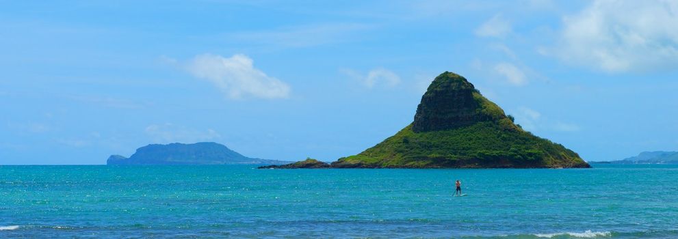 A verdant green rock formation off the coast of Oahu, Hawaii