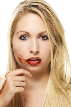 beautiful blonde woman after eating chocolate on white background