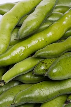 Close up view of some broad beans isolated on a white background.