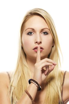 beautiful blonde woman holding finger at her mouth on white background