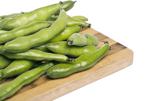 Close up view of some broad beans isolated on a white background.