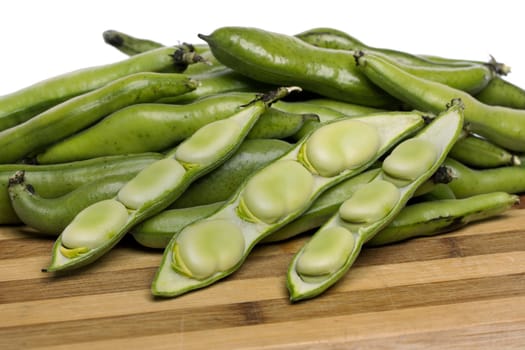 Close up view of some broad beans isolated on a white background.