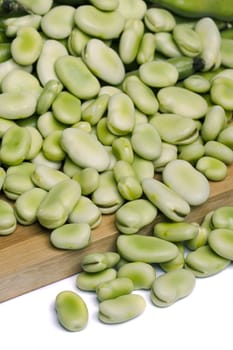 Close up view of some broad beans isolated on a white background.