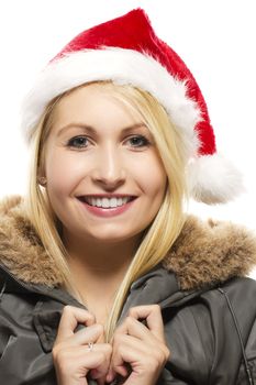 beautiful laughing blonde woman in a parka wearing santa's hat on white background