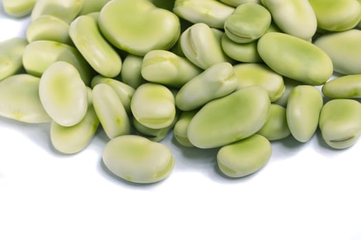 Close up view of some broad beans isolated on a white background.