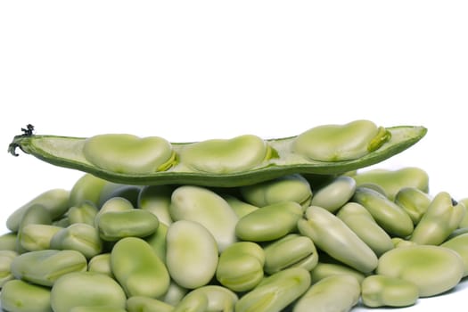 Close up view of some broad beans isolated on a white background.