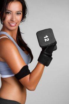Fit exercising woman lifting weights