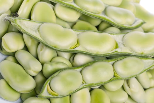 Close up view of some broad beans isolated on a white background.