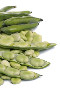 Close up view of some broad beans isolated on a white background.