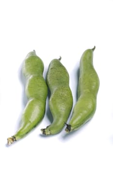 Close up view of some broad beans isolated on a white background.