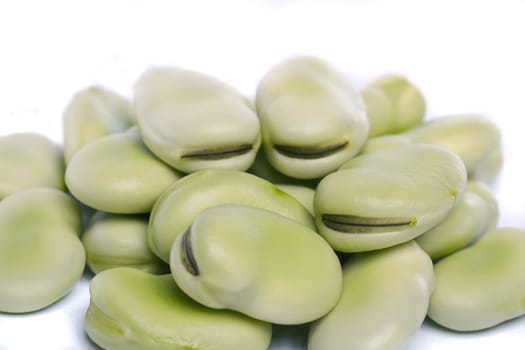 Close up view of some broad beans isolated on a white background.
