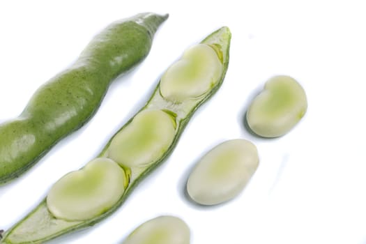Close up view of some broad beans isolated on a white background.