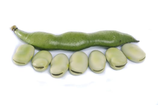 Close up view of some broad beans isolated on a white background.