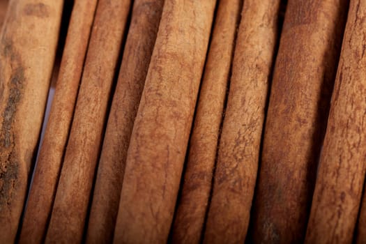 View of a bunch of cinnamon spice quills isolated on a white background.