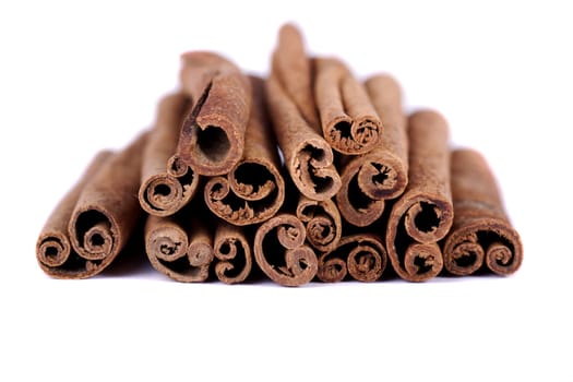 View of a bunch of cinnamon spice quills isolated on a white background.