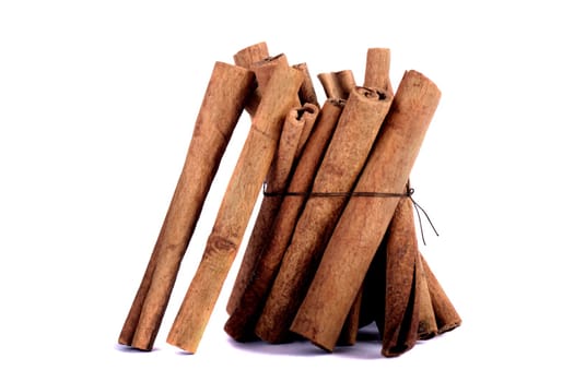 View of a bunch of cinnamon spice quills isolated on a white background.