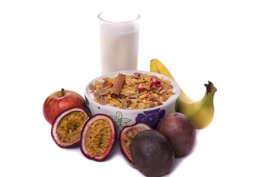 Detail view of a bowl of breakfast cereals surrounded by fruit.