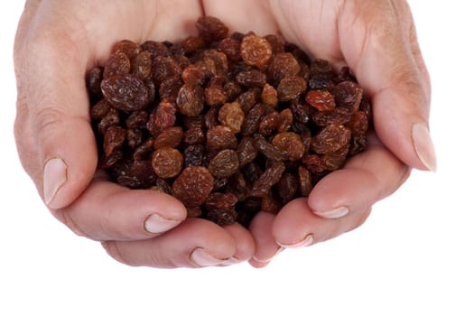 Close view of a pair of hands holding some raisins isolated on a white background.