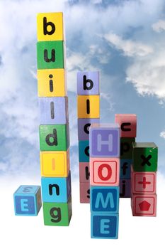 toy letters that spell home building blocks with cloud background and clipping path