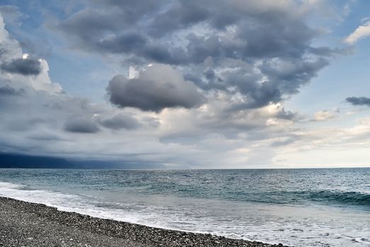 Bad weather seascape with cloudy sky and water wave.