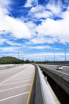 road through the bridge with blue sky background of a city, hong kong