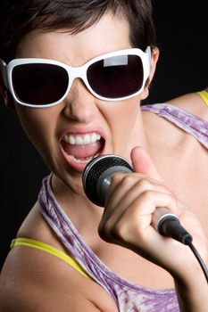 Beautiful girl singing into microphone