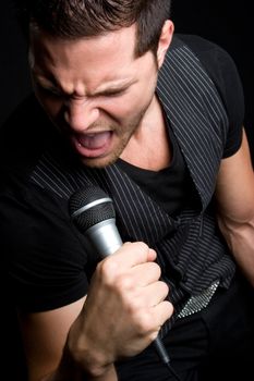 Young man singing into microphone