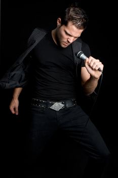 Sexy man singing into microphone