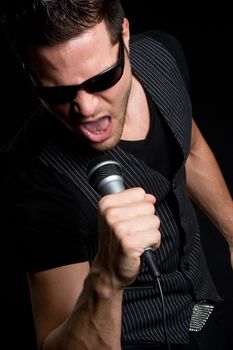 Young man singing into microphone