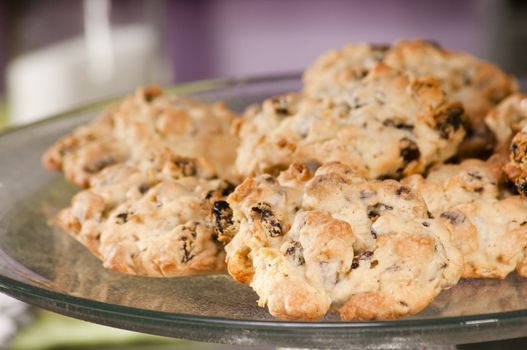 baked chocolate chip and raisin cookies on a glass dish 