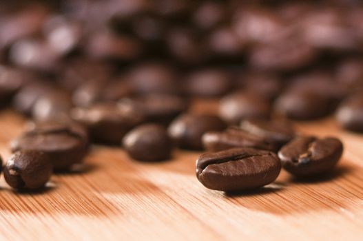 roasted coffee beans on a bamboo board