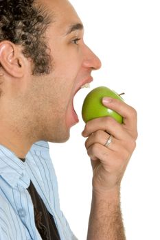 Young man eating green apple