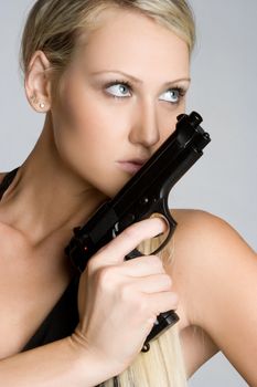 Sexy blond woman holding gun