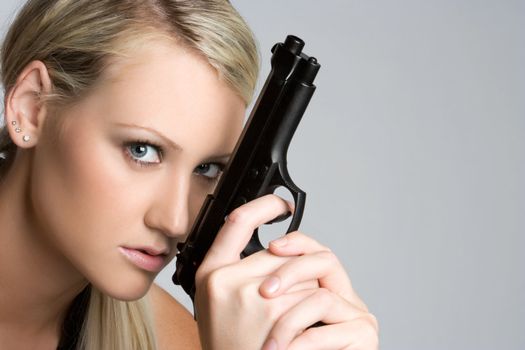 Blond woman holding gun