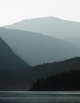 layers of mountain in fog