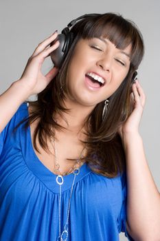 Singing asian girl wearing headphones