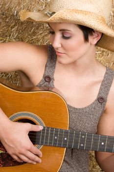 Beautiful country woman playing guitar