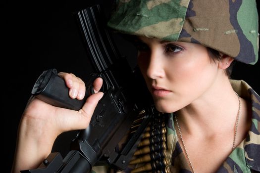 Beautiful military woman holding gun