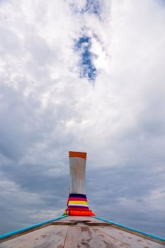 Nose of wooden boat decorated with ribbons