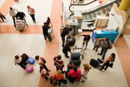 Crowd of people packing their luggage in the airport 