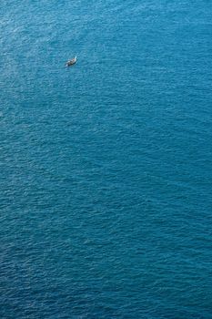 Single boat in the blue tranquil sea