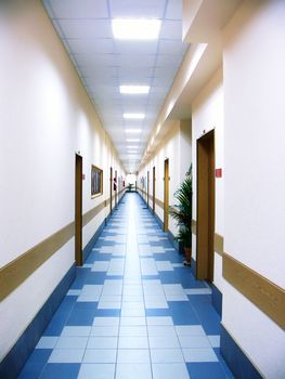 Perspective view of the long corridor at office centre
