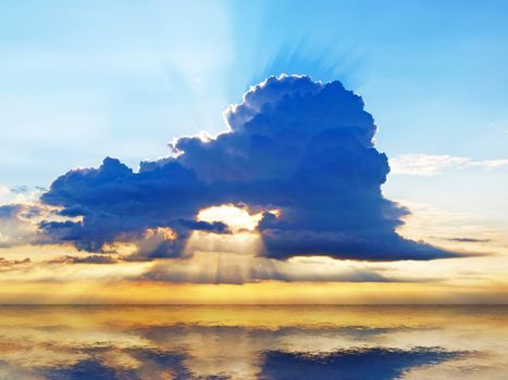 Bright sunset sky with stormy clouds over a ocean