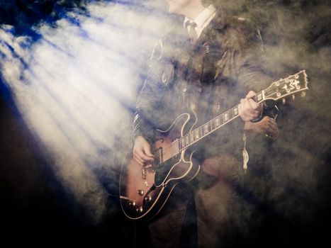 Guitar player at a concert, high ISO