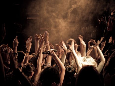 Crowd at a concert with hands up