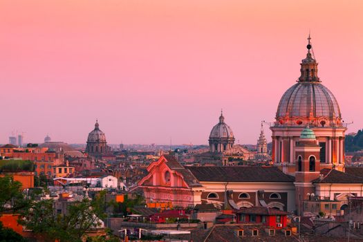 Rome skyline at dusk. In the foreground San Carlo al Corso Church.