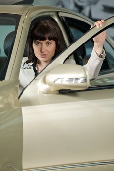 Young woman sitting in new car
