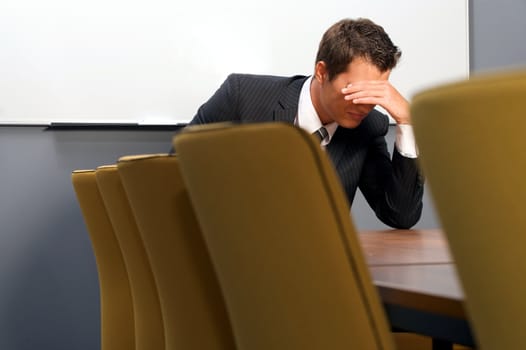 Despaired businessman sitting in office