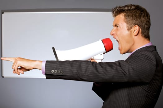 Businessman shouting through megaphone